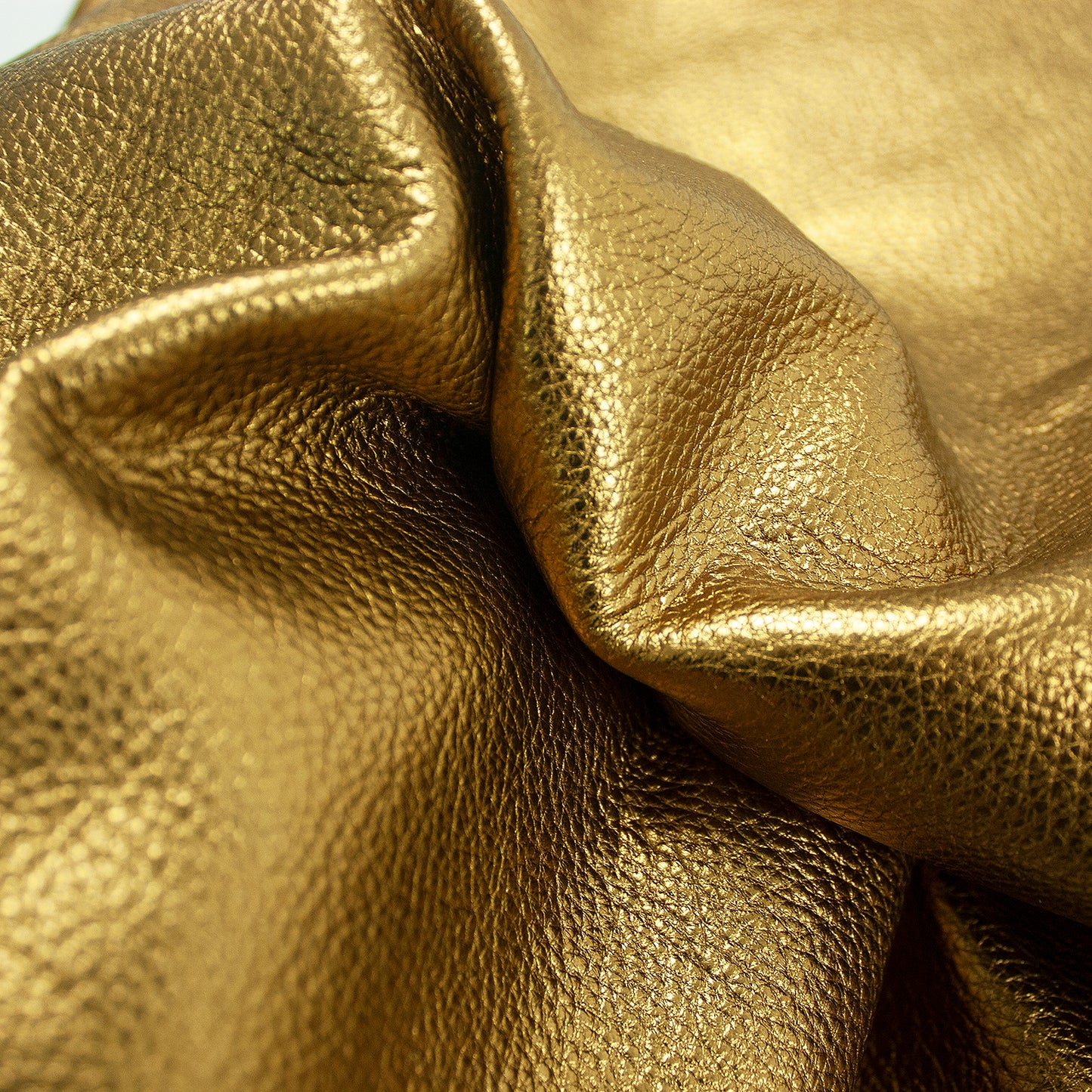 Piece of gold laminated pumped bovine leather