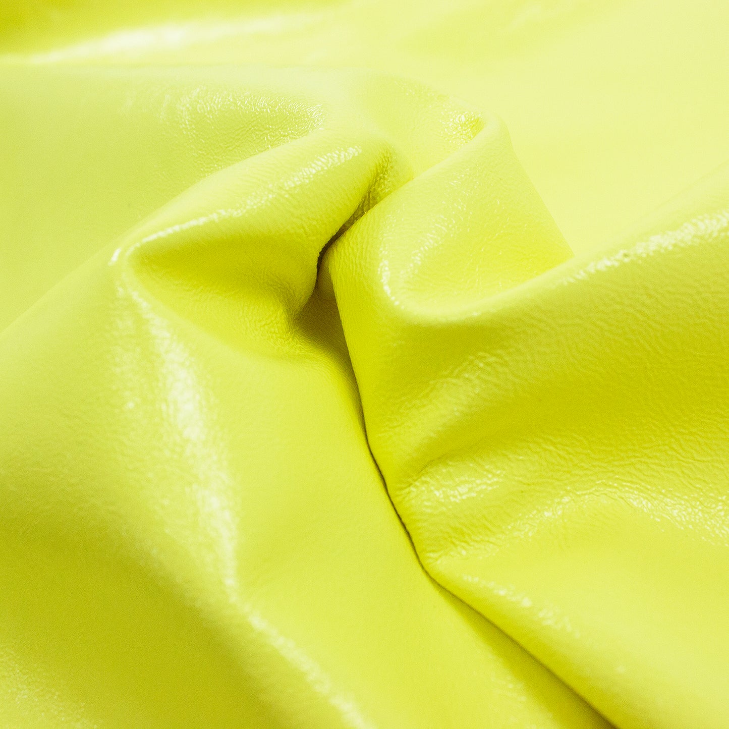 Piece of yellow wrinkled patent leather