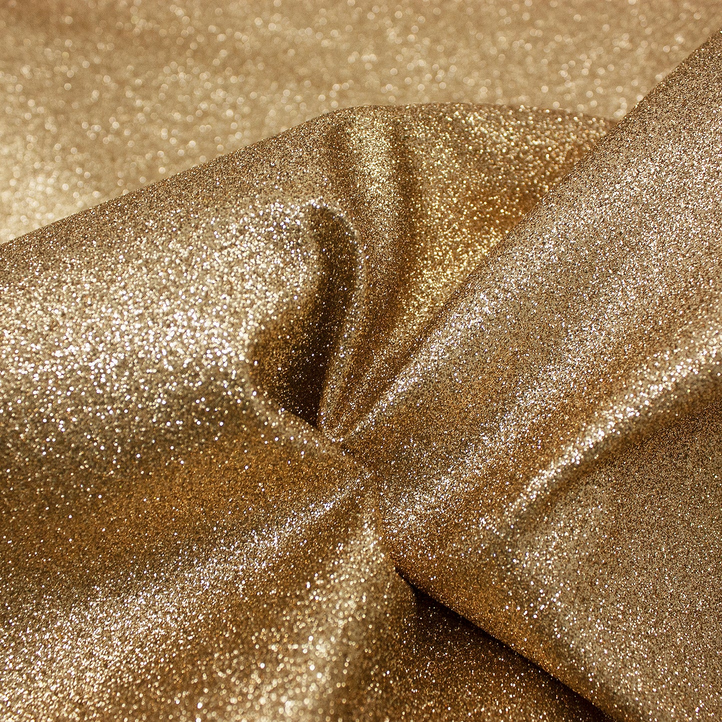 Trozo de tejido purpurina dorada