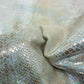 Piece of worn multi-colored faux snake skin